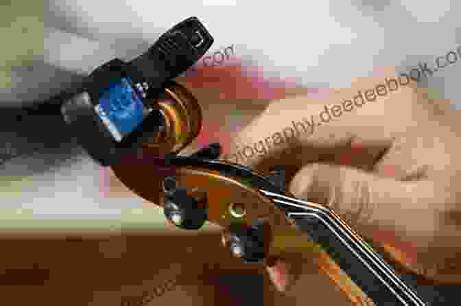 A Person Tuning A Violin Using A Tuner Violin For Dummies 2nd Edition