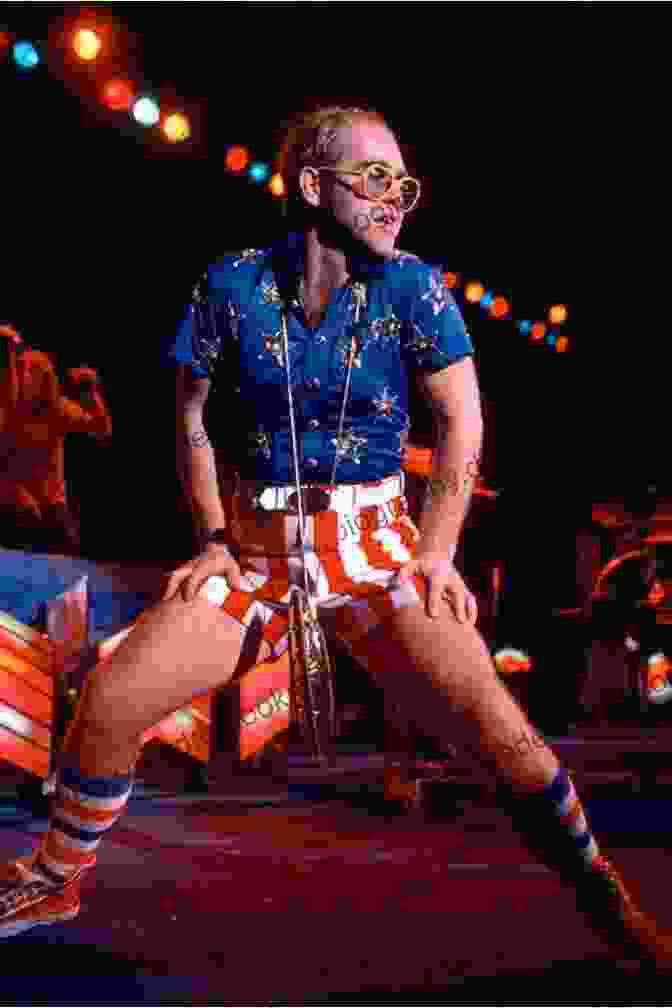 A Photo Of Elton John In The Early 1970s, Wearing A Colorful Stage Outfit, Playing The Piano With A Flamboyant Pose The Great Songwriters Beginnings Vol 2: Paul Simon And Brian Wilson
